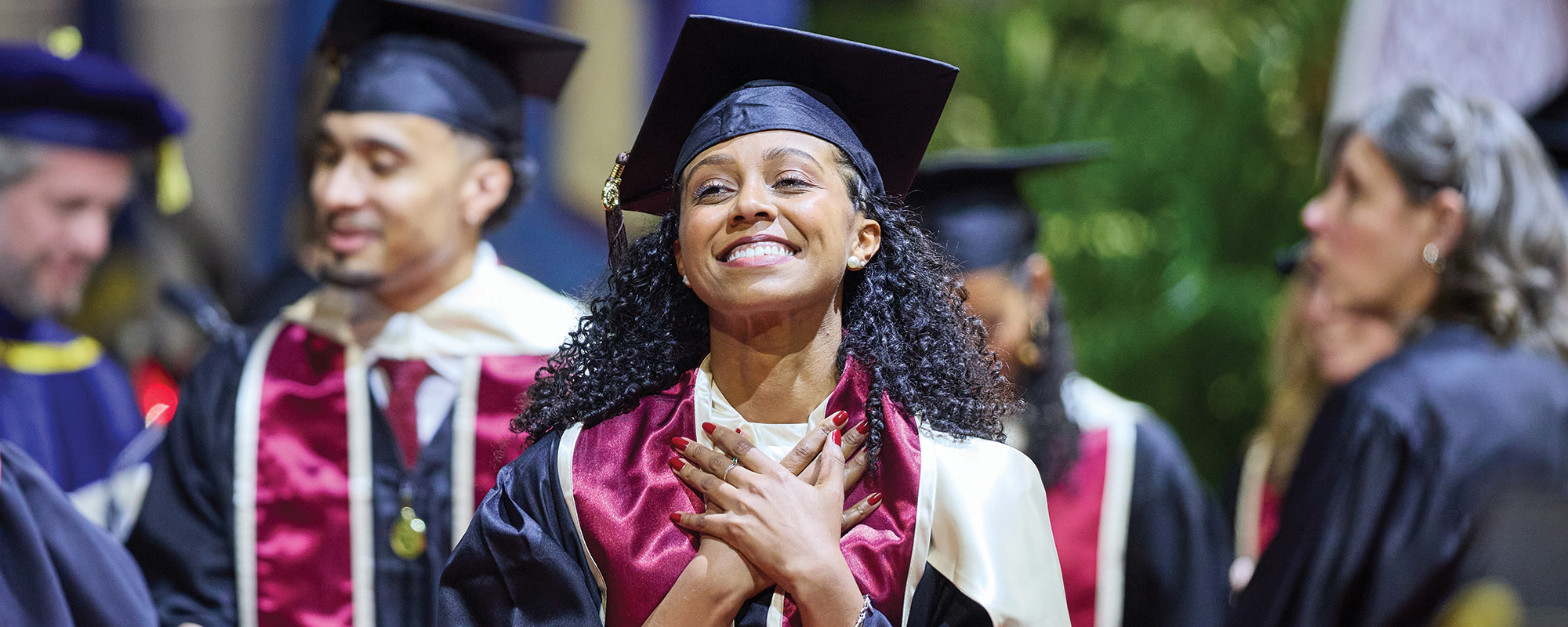 Graduates clapping during ceremony.