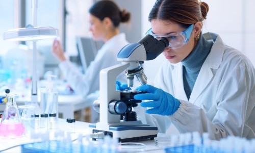 Woman looking through microscope