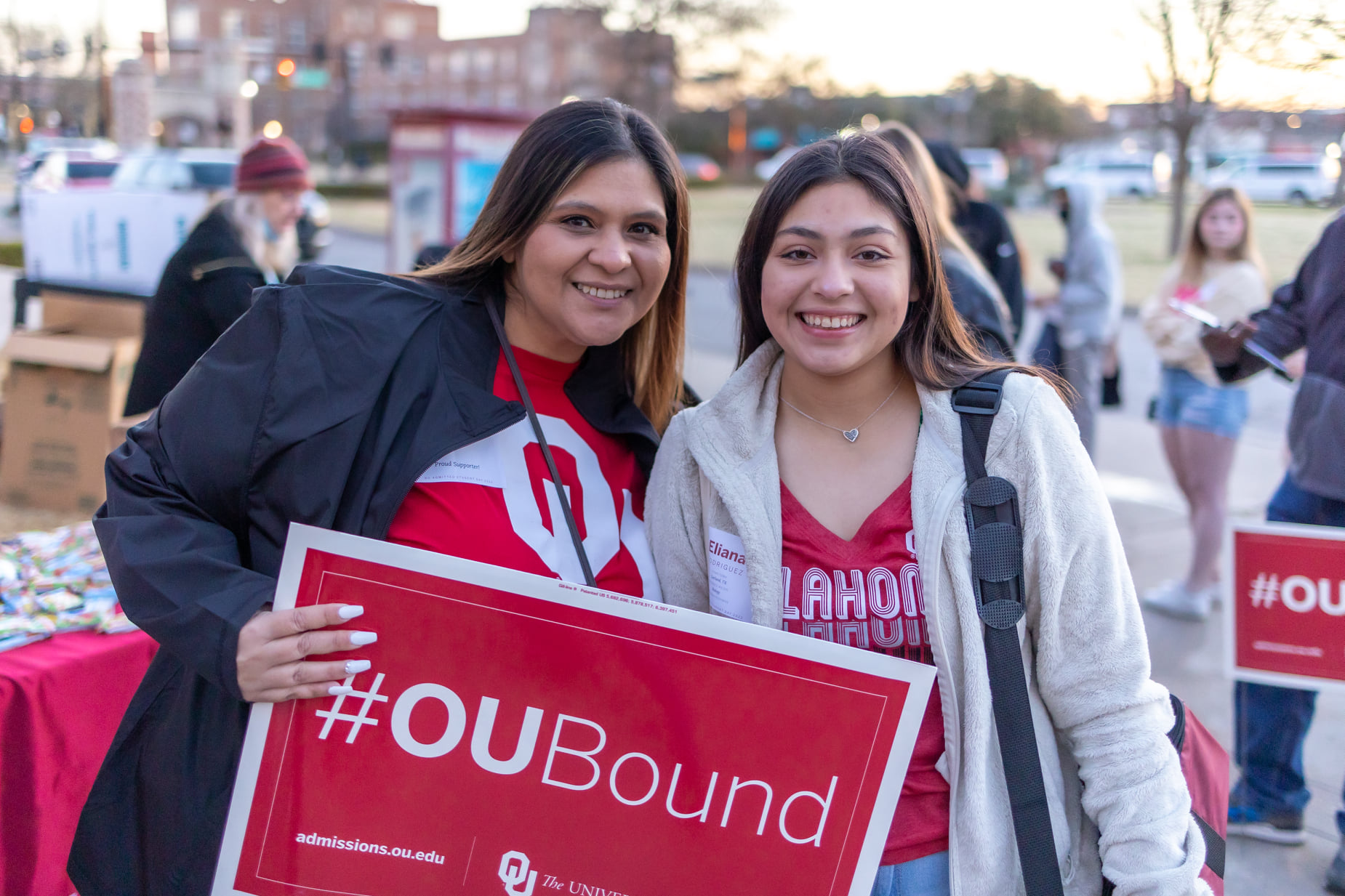 Two people holding an OU Bound sign