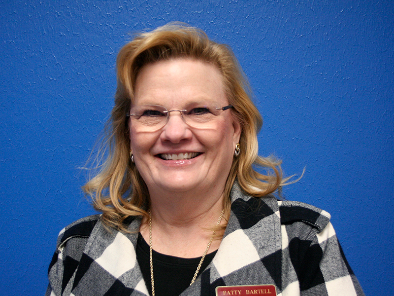 picture of a woman with a blue background wearing a black and white jacket