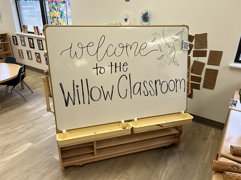 a large whiteboard on a stand in a classroom with the words "Welcome to the Willow Classroom"