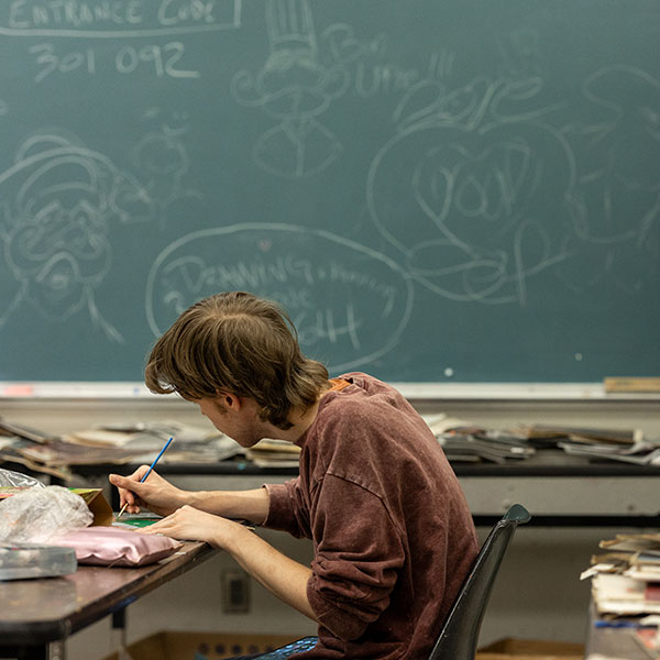 Student working at desk.