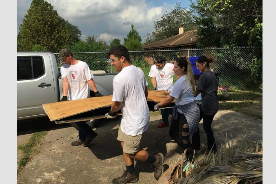 O U students carrying building materials.