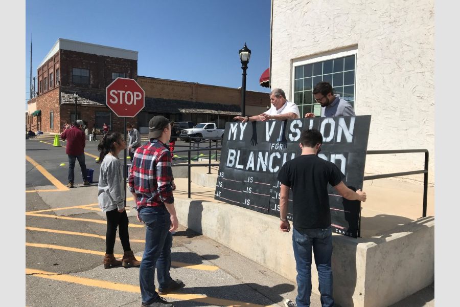Students near an intersection with an interactive sign that says "My Vision for Blanchard".