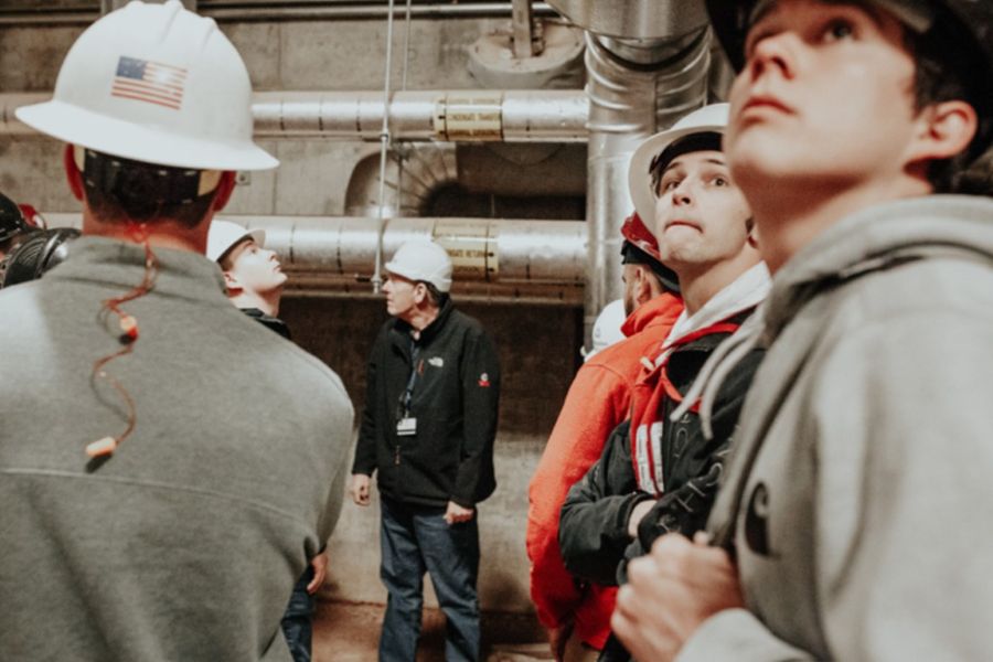 Students in hard hats at a power plant.