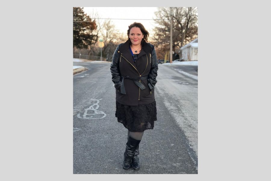Full length photo of a woman standing on a street in all black clothing