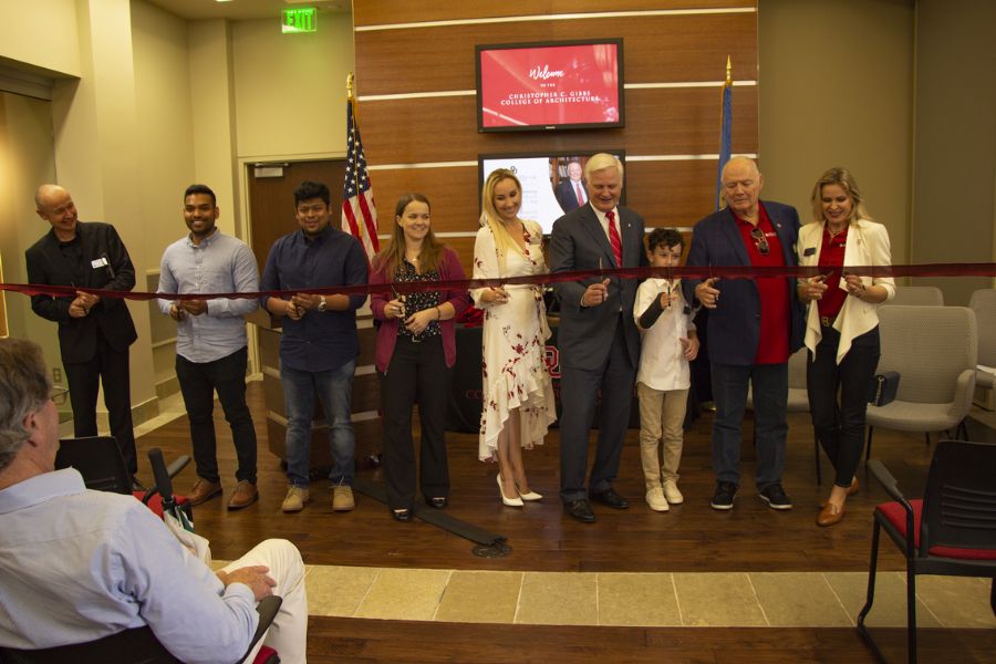 Chris and Ania Gibbs, alongside President Gallogly, Dean Hans E. Butzer, family, and students, cut a ribbon in recognition of the naming of the Christopher C. Gibbs College of Architecture.