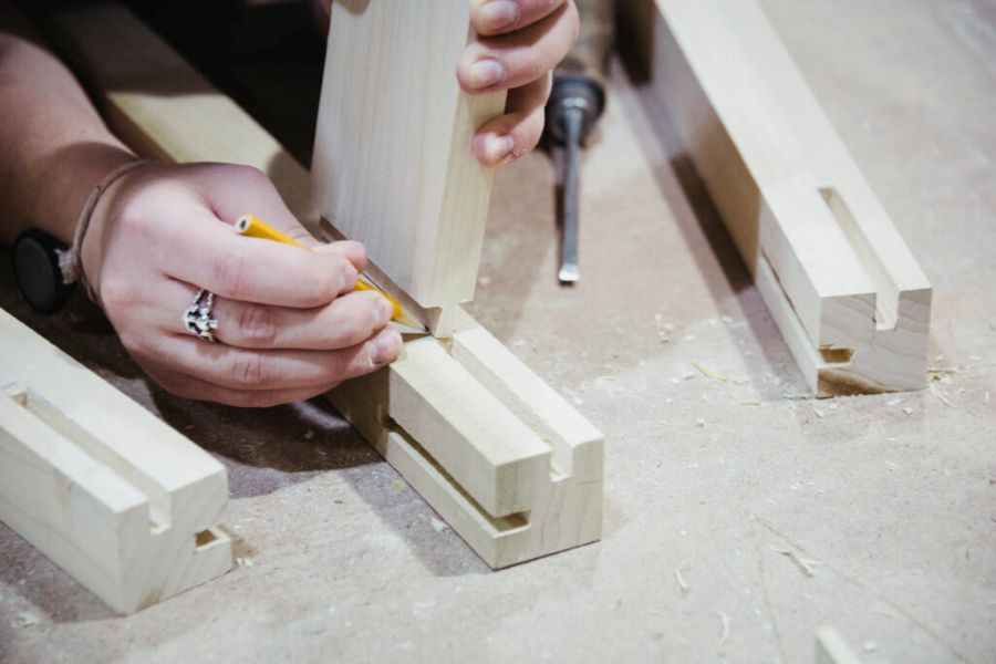 A student building wooden furniture.