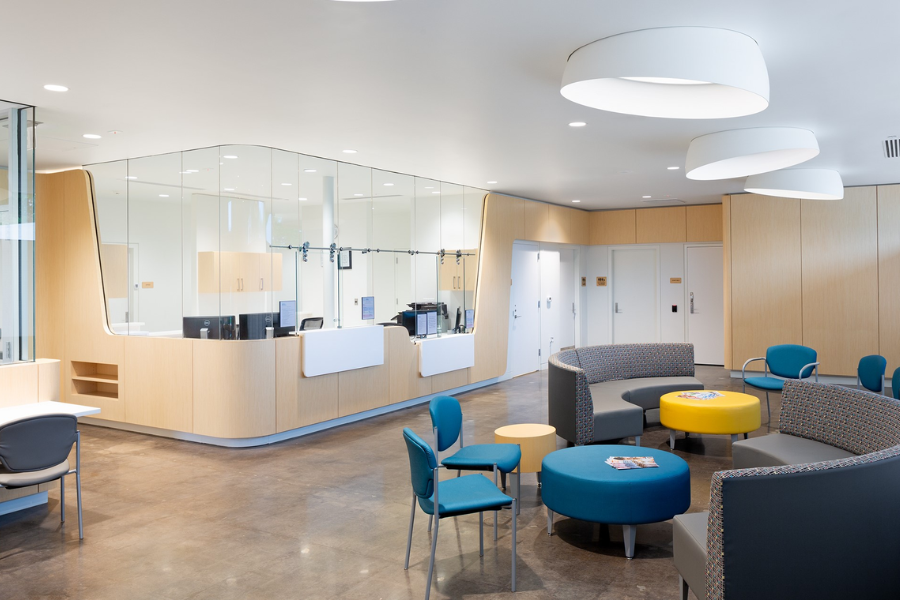 Photo of waiting room at health center with blue and yellow chairs