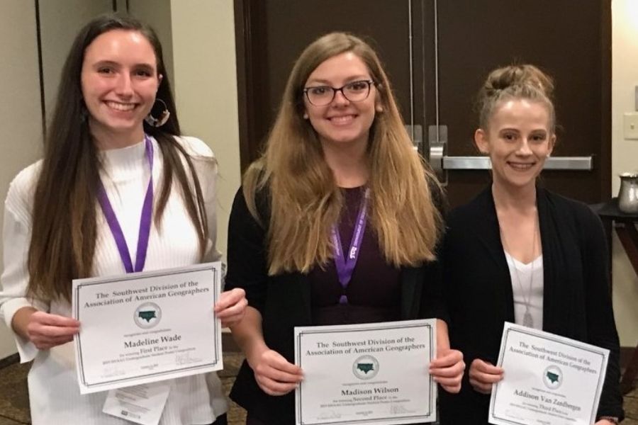 A group of students holding award certificates