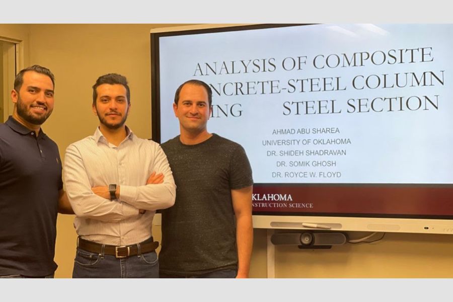 Ahmad Abu Sharea with colleagues in front of a presentation about the analysis of composite concrete-steel columns.