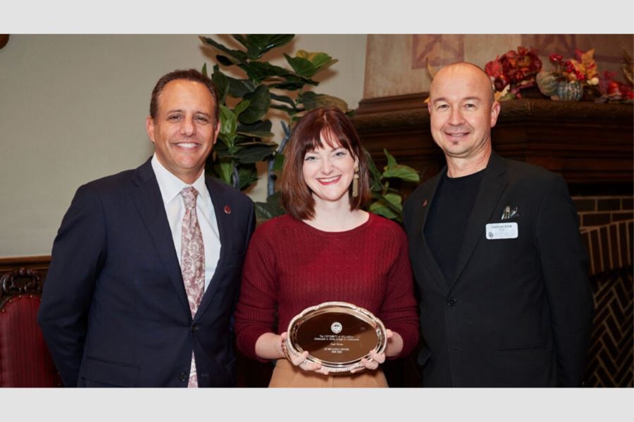 Student accepting award with O U President Joseph Harroz and Dean Butzer.