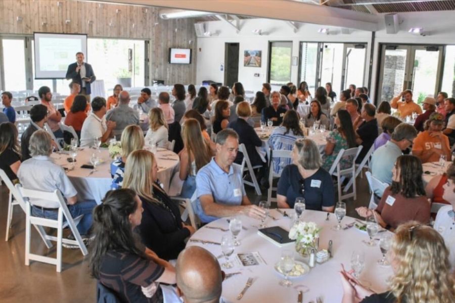People seated at tables during the 2023 O K A S L A meeting.