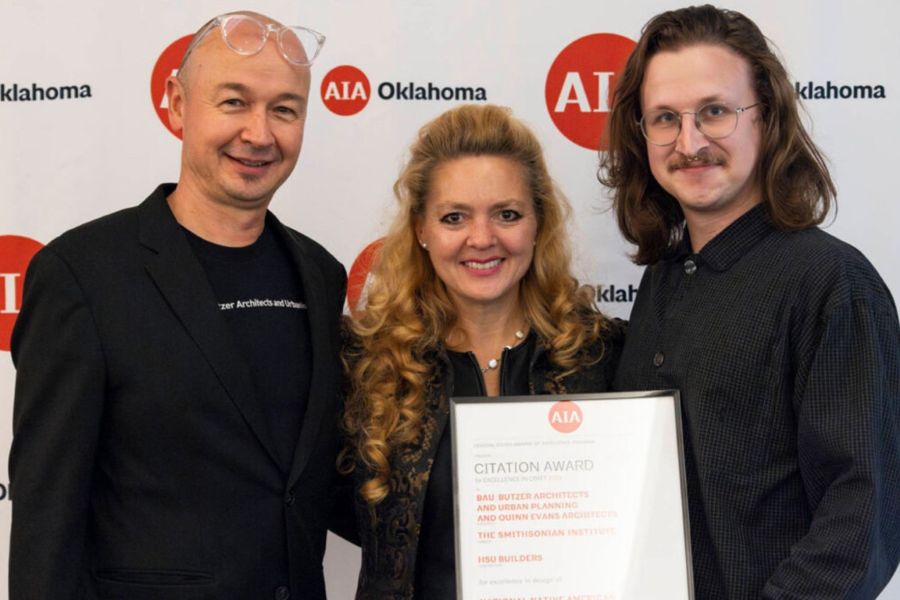 Hans Butzer, Torrey Butzer, and Evan Sack from B A U Architects with an award from A I A Oklahoma.