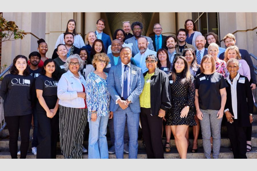 A group photo of Clyde Higgs and event attendees.