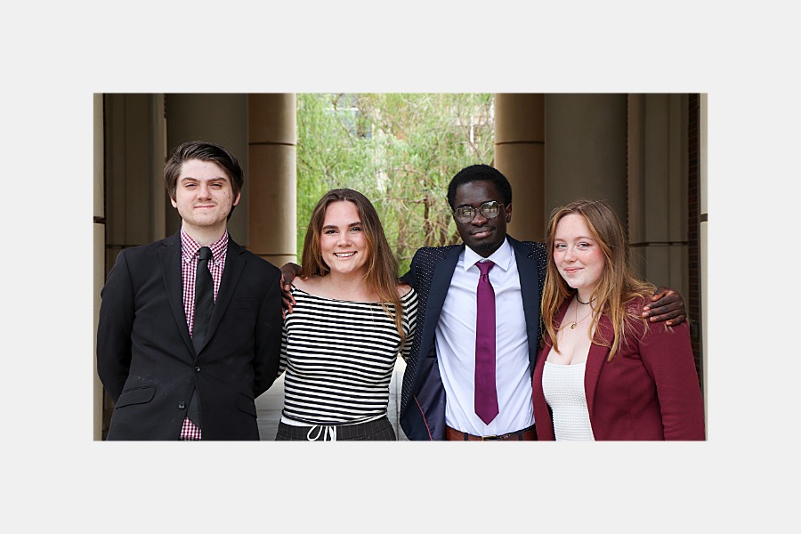 Four O U students standing outside of Gould Hall. 