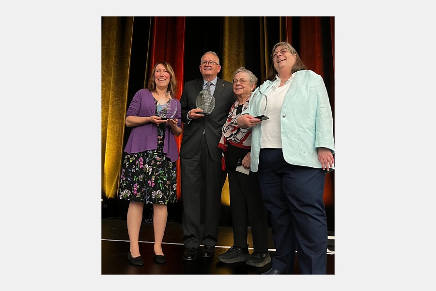 Ron Frantz and 3 other people accepting awards on stage.