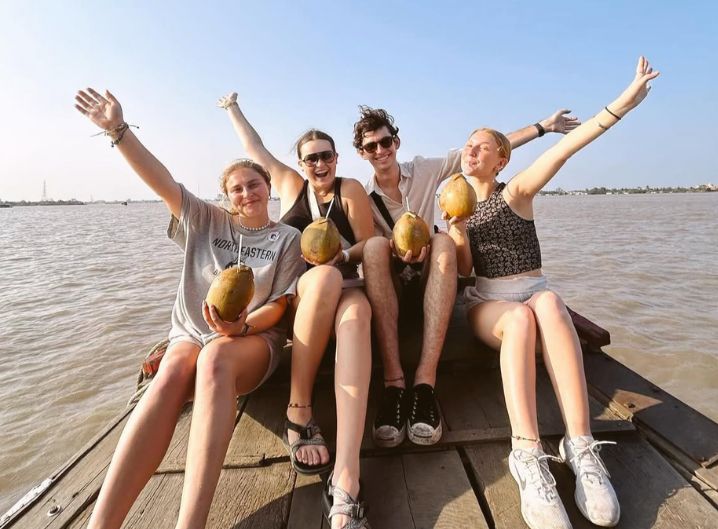 students posing with fruit