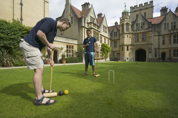 Two students playing croquet at Oxford.