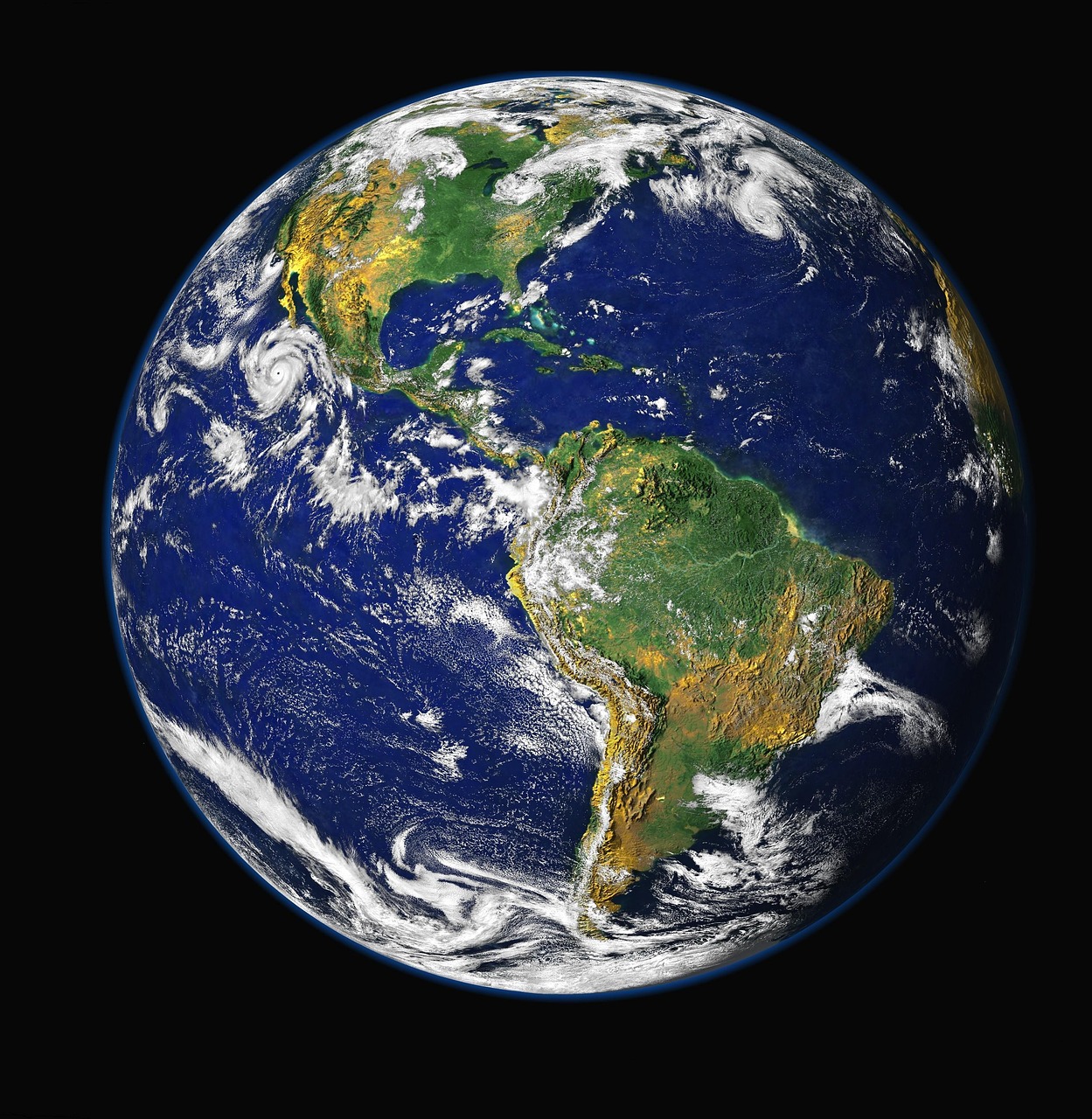 A view of the earth from space. The continents showing in green and brown while the ocean is blue. There is moderate cloud cover shown in the image.