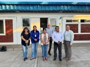 A group of researchers from LASI and UNSA pose in front of a building.