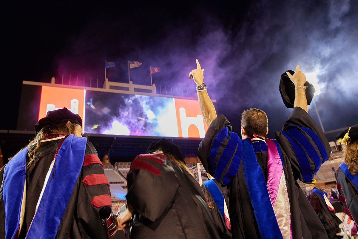 Graduates celebrating with fireworks after the University of Oklahoma Commencement Ceremony in the Gaylord Family Oklahoma Memorial Stadium.