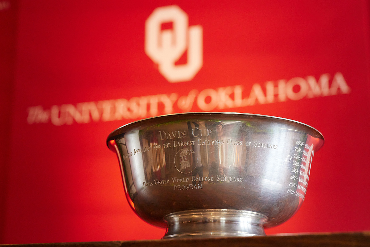 Davis Cup trophy in front of University of Oklahoma banner.
