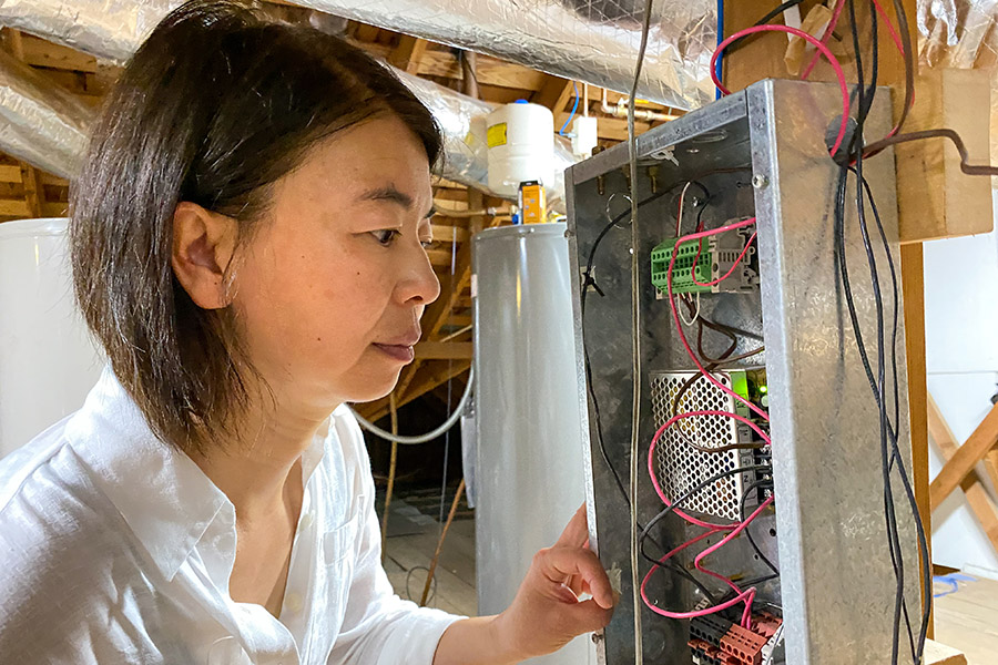 Li Song, Ph.D., a faculty member in the School of Aerospace and Mechanical Engineering, Gallogly College of Engineering, University of Oklahoma, looking at wires in her lab.