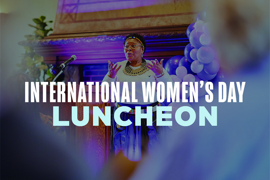 International Women's Day Luncheon overlaying image of a woman talking during an event on campus.
