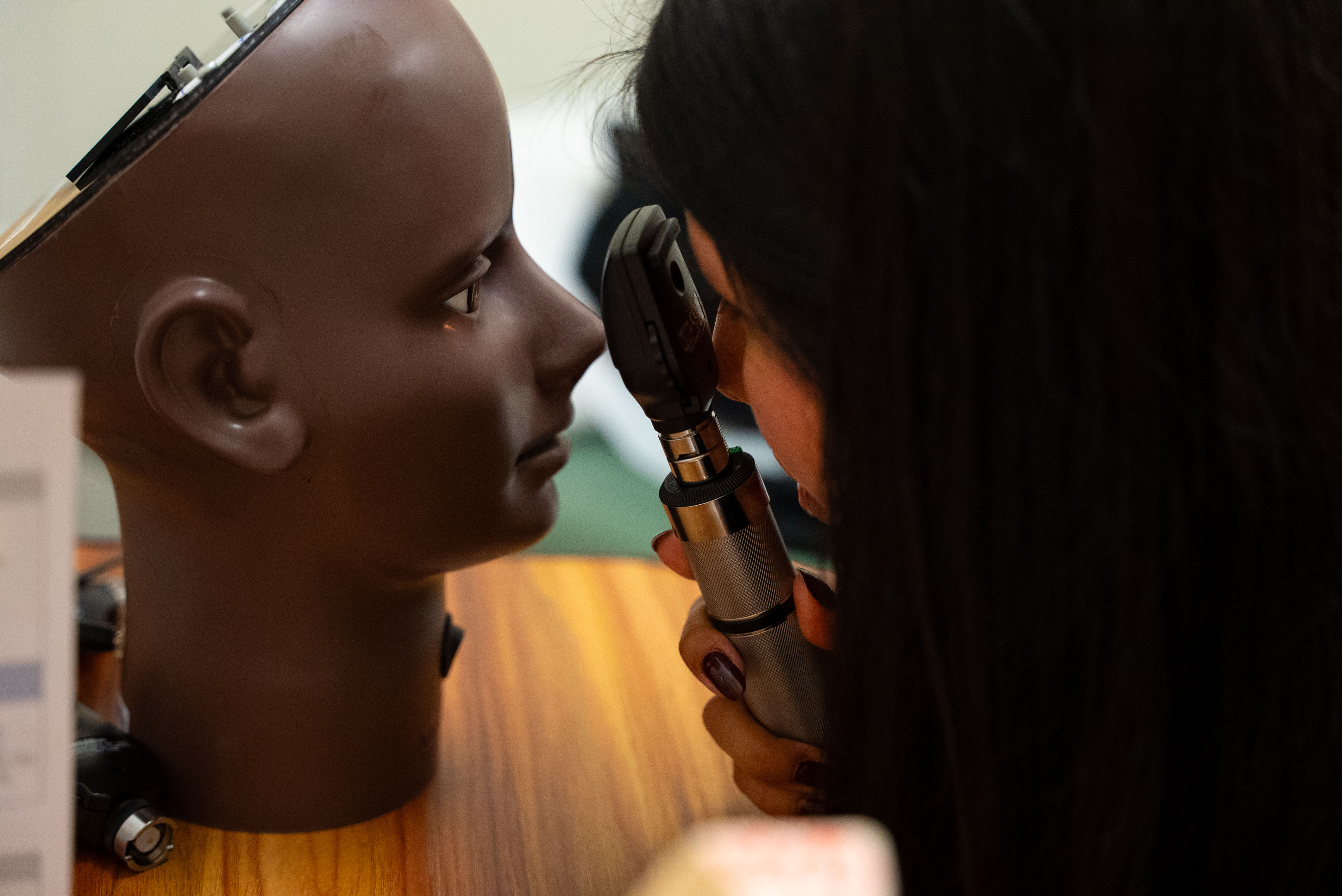 A participant at Pre-Med Day conducts a simulated eye exam.