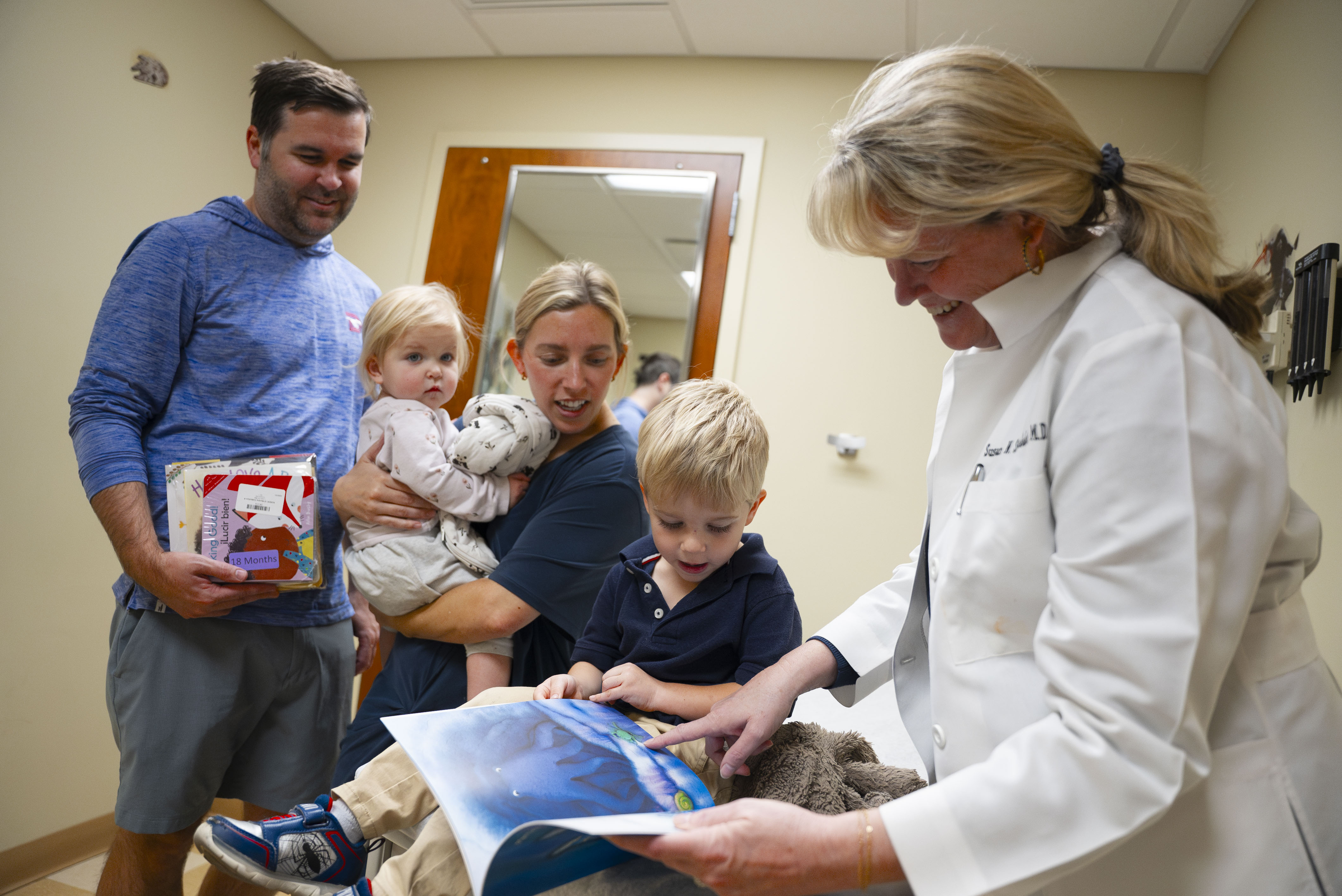  A family enjoys their new books at their child’s check-up appointment.