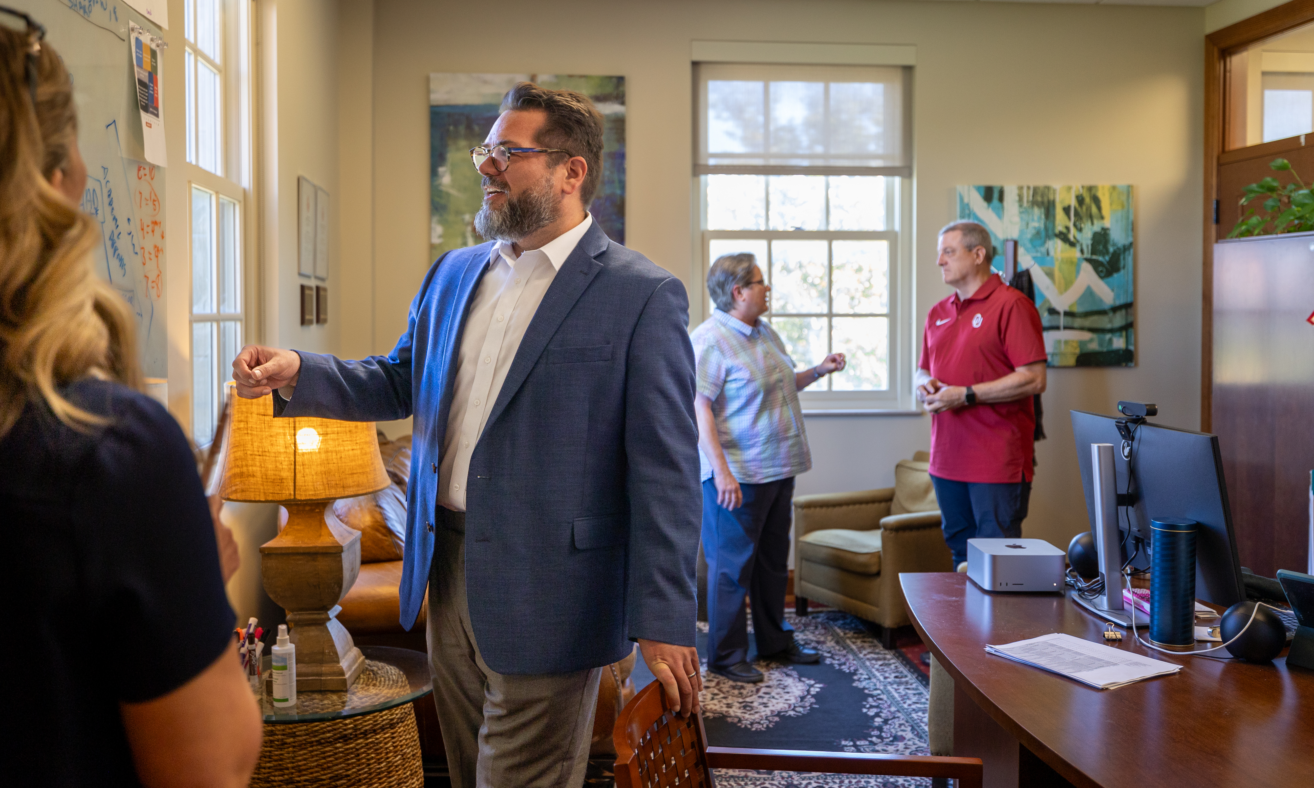 Interim Director David McLeod discusses strategy with Anne and Henry Zarrow School of Social Work professors and staff.