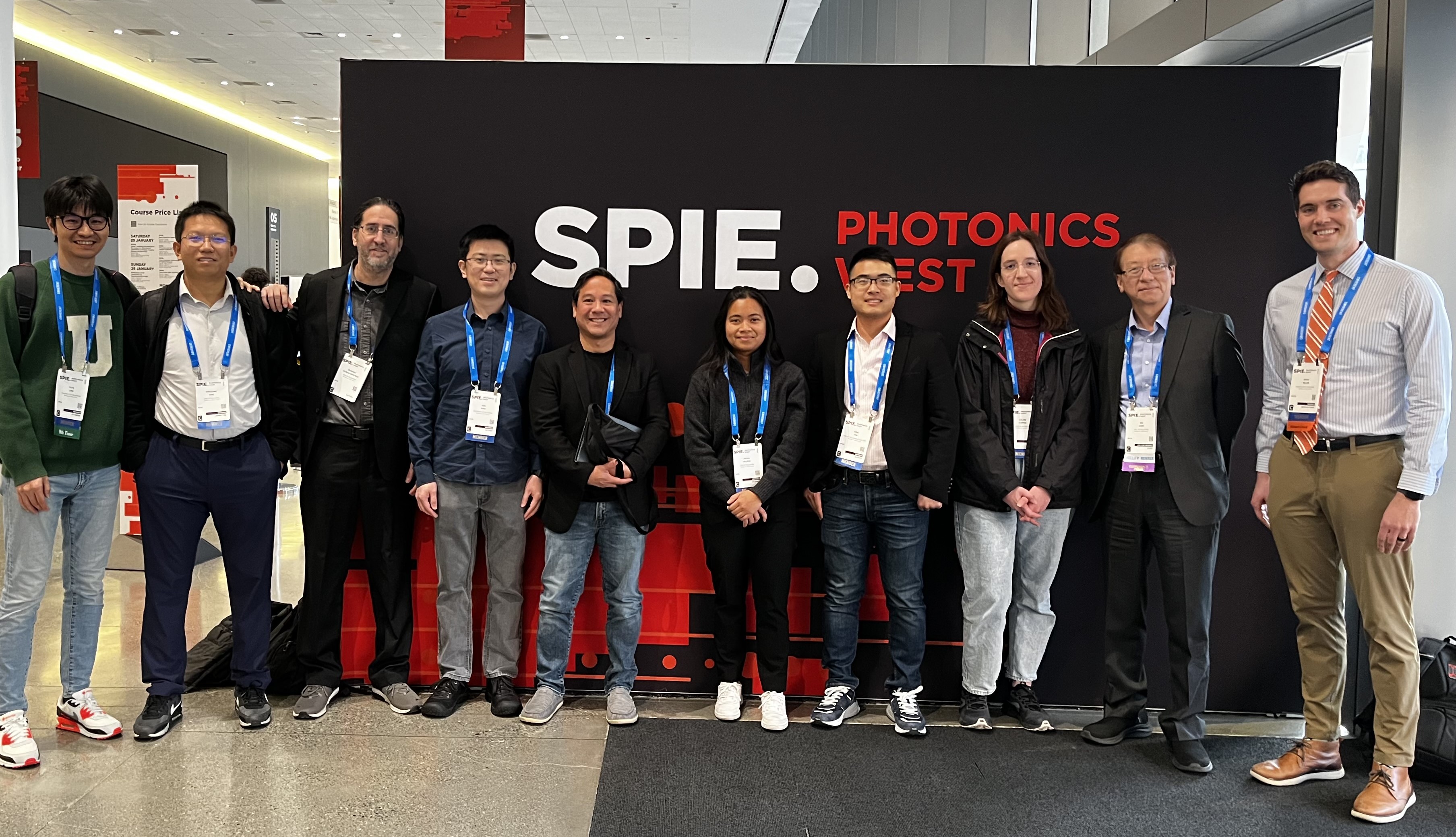 Conference attendees from OU in front of the SPIE logo.