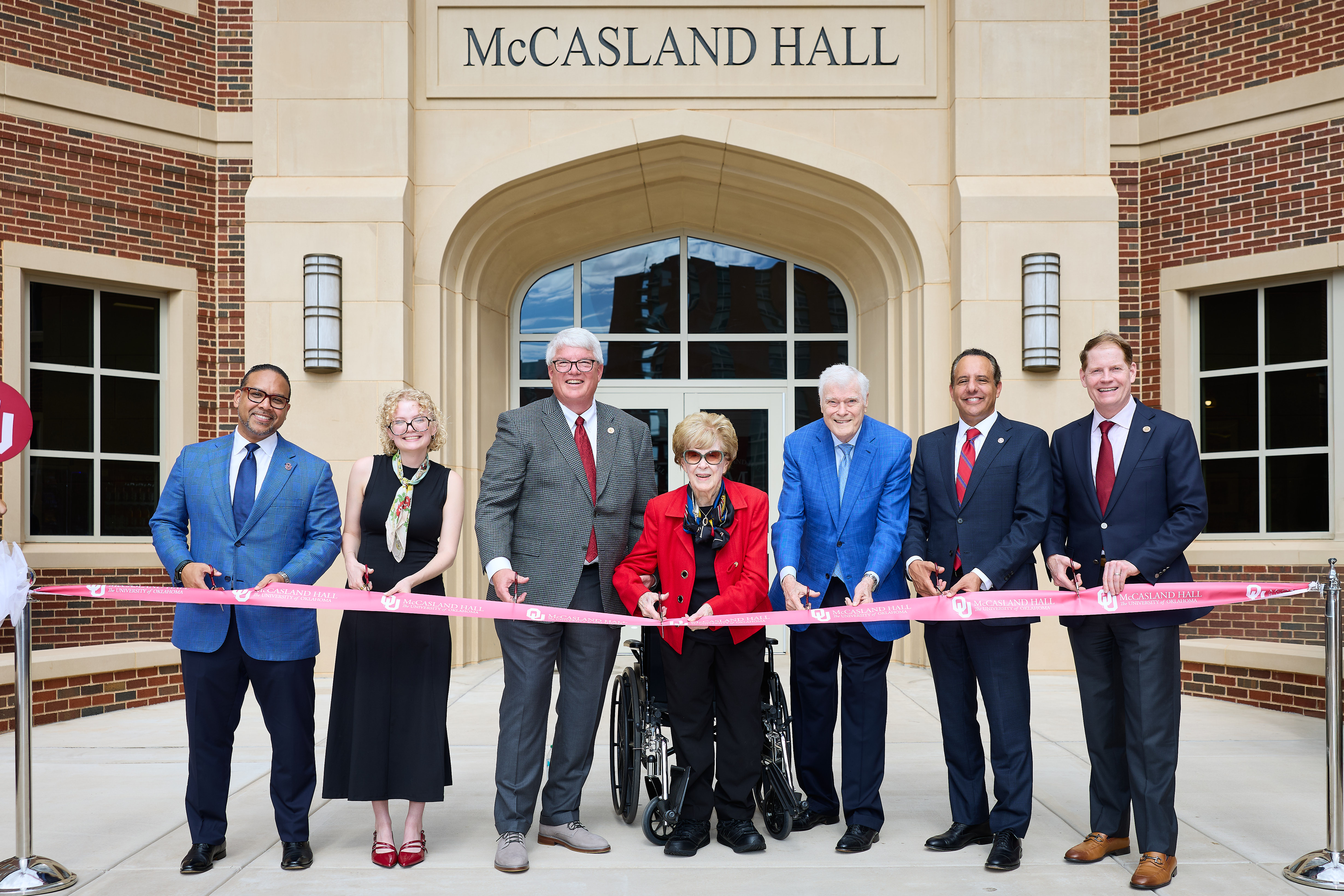 Photo of a ribbon cutting outside of McCasland Hall.