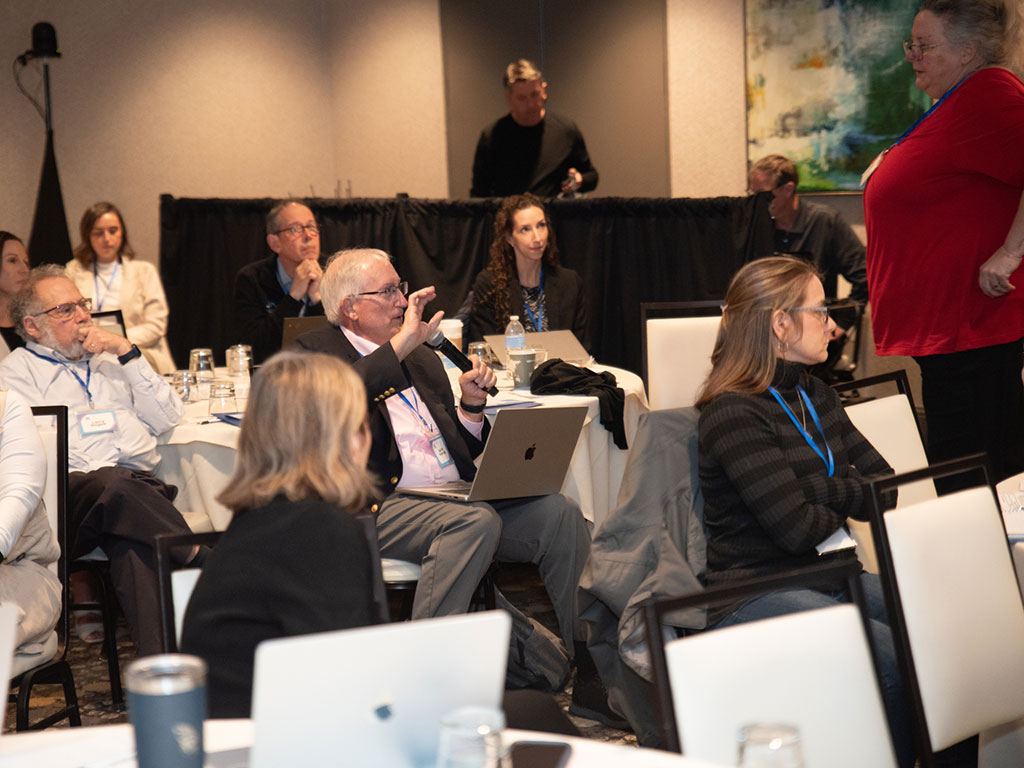 A man asking a question at a conference.