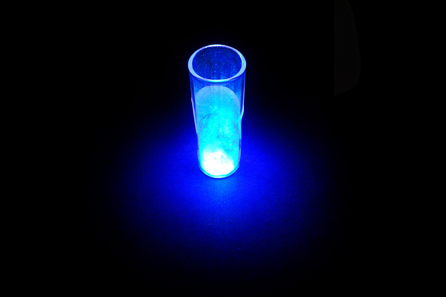 A vial filled with glowing blue liquid. 