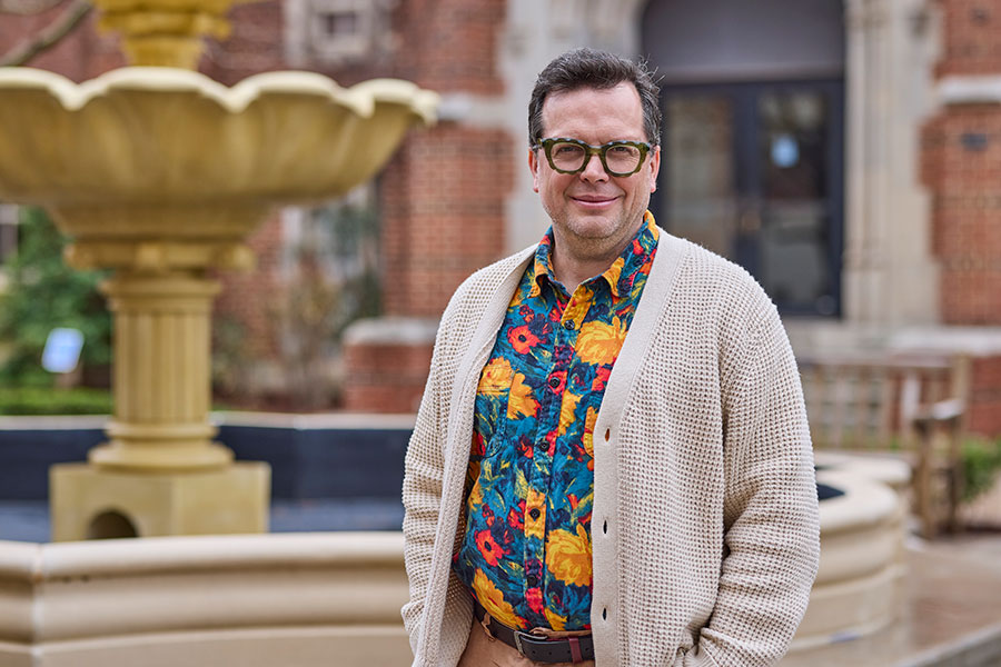 Man standing in front of fountain.