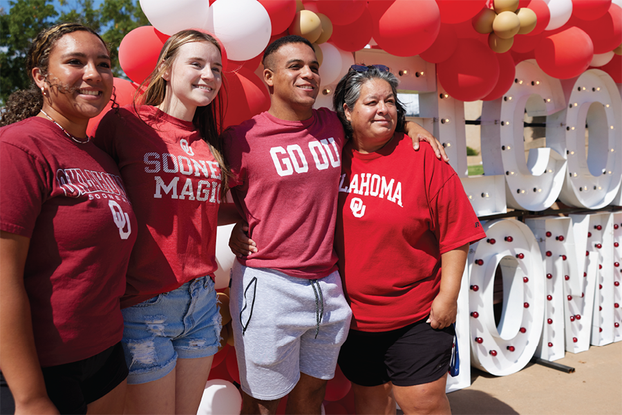 Family smiling during OU move-in, August 8, 2023.