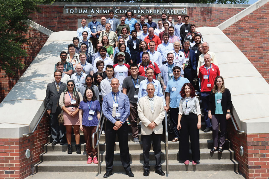 Attendees at the International Precipitation Conference standing outdoors on the steps of a building on The University of Oklahoma Norman campus