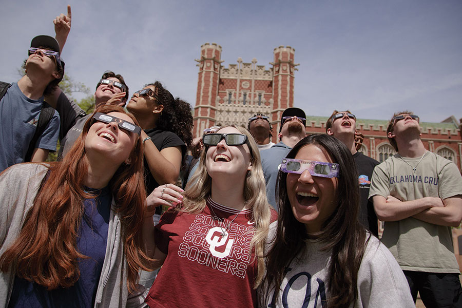 OU students viewing a solar eclipse with special glasses.