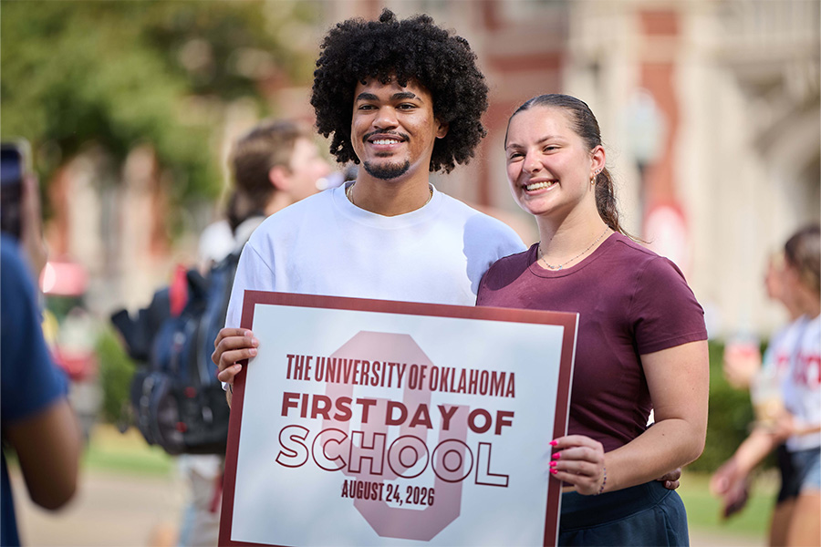 O U students holding a first day of school sign.