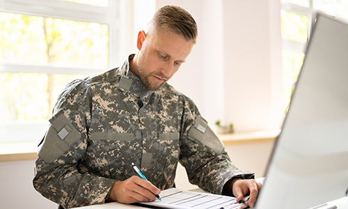 soldier using laptop for course work
