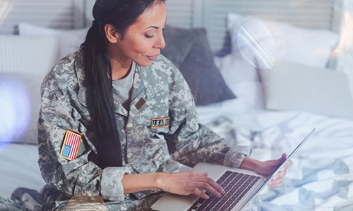 female soldier using laptop