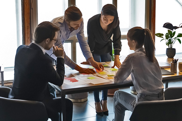 A group of people analyzing information in an office setting.