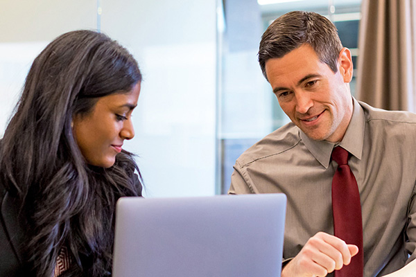 Man and woman looking at computer