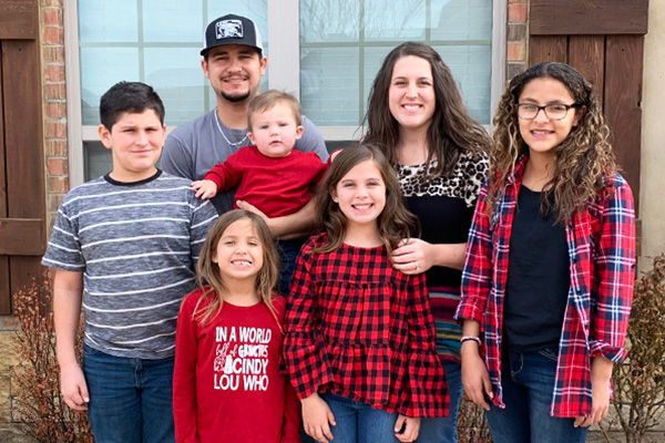 Tanna Rosalez and her family pose for a photo