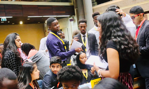 Delegates debating in a session