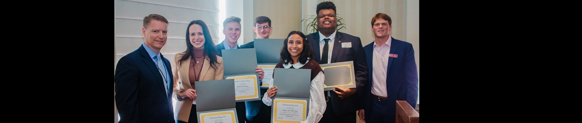 Students pose for a photo with their awards during the CMISS retreat