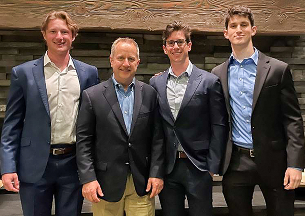 Price College of Business finance students who competed in the 2022 Financial Modeling University Championship are pictured with the professor who helped them prepare for the competition. Pictured, from left, are Cooper Browning, finance professor Tom Hooper, Daniel Dempster and Jonah Barth.