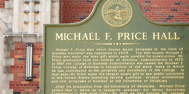 Exterior of Price Hall focusing on the historical plaque outside the building which reads Michael F. Price Hall which tells the history of the building
